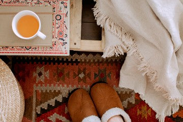 cup with shoes and red carpet on the floor