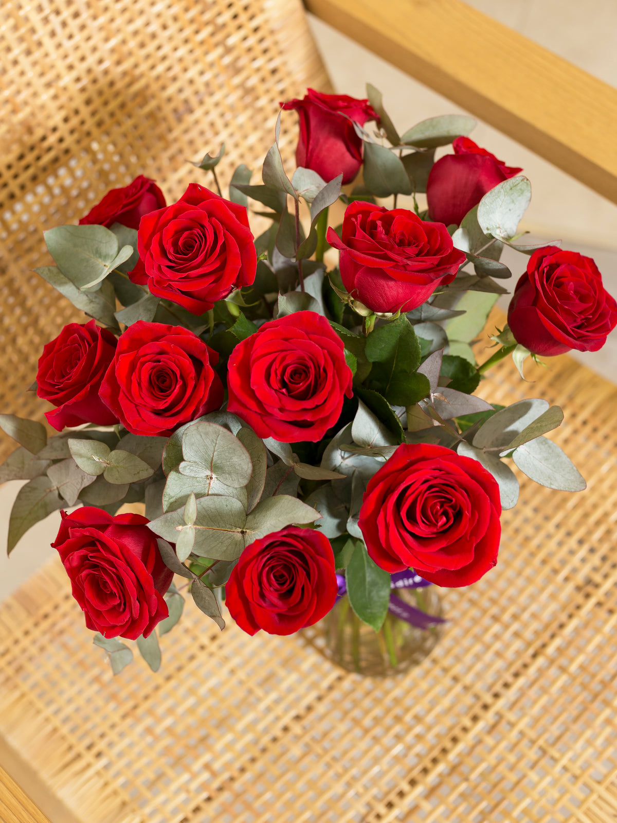 Dozen Red Roses in a vase with a box of Lily O&#39;Brien&#39;s Crispy Hearts Chocolates