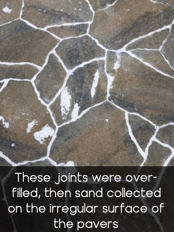 Sand wasn't removed from paver surface