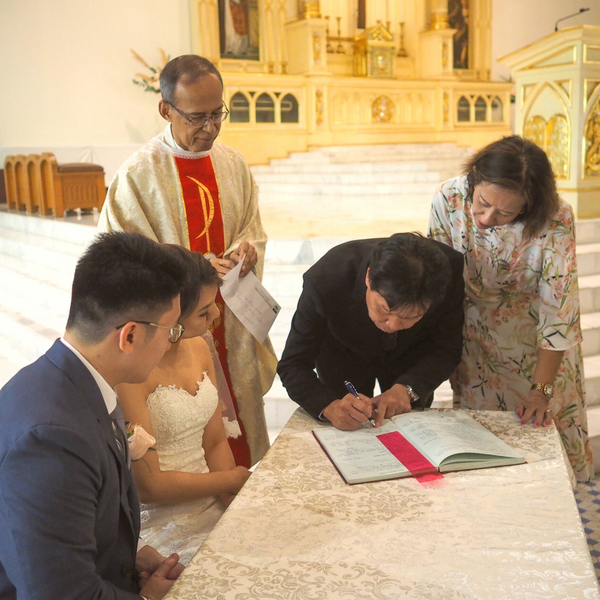 Primary wedding sponsors legally witness and sign the marriage certificate. Photo by John Ragai