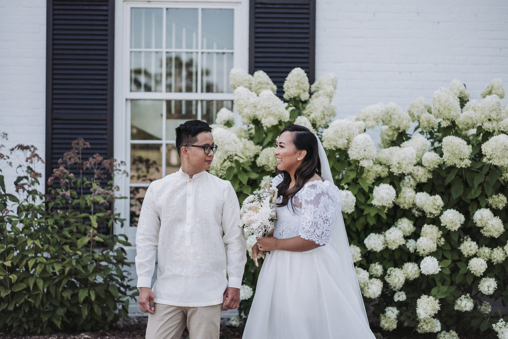 A custom-made wedding gown with floral lace patterns on the traditional Filipino terno or butterfly sleeves.