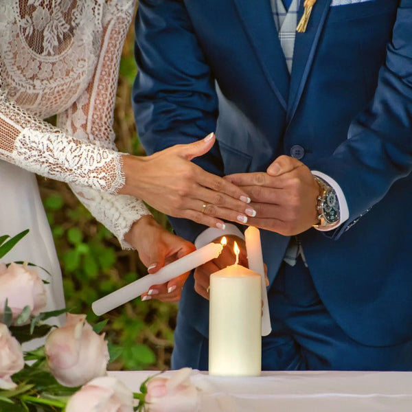 The lighting of a unity candle is a traditional wedding rite, symbolizing the merging of two lives. 
