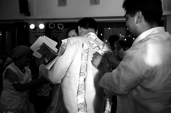 A natural concern for brides and grooms about the money dance is how to preserve their wedding gown and barong amid all the pins.