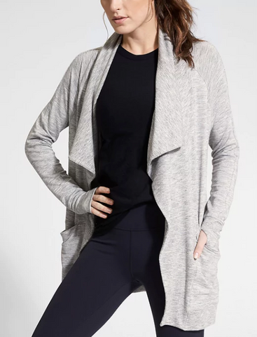 Woman wearing athletic clothes and a coat