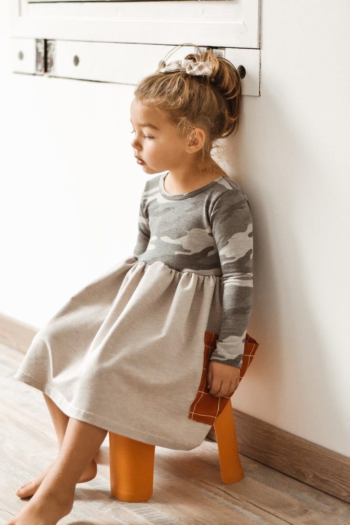 young girl sitting on stool wearing lowland kids taken with photo tip