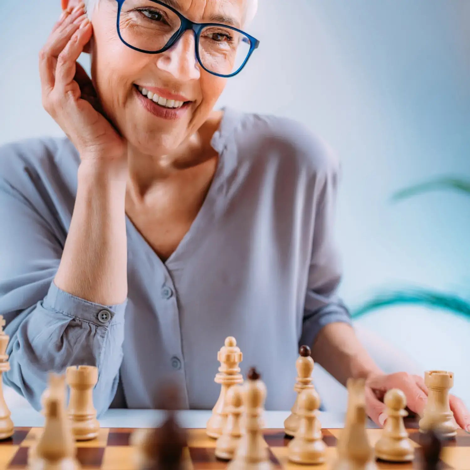 Woman playing chess, symbolizing cognitive performance and mental clarity.