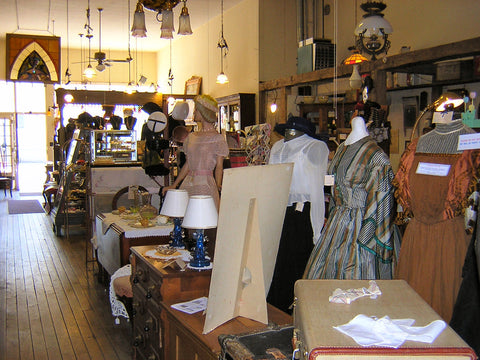Brick and mortar shop display of antique dresses