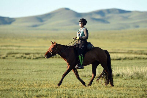 Devan Horn wearing her FITS Tech Tread Breeches and Cloudmax Rain Coat during the Mongol Derby