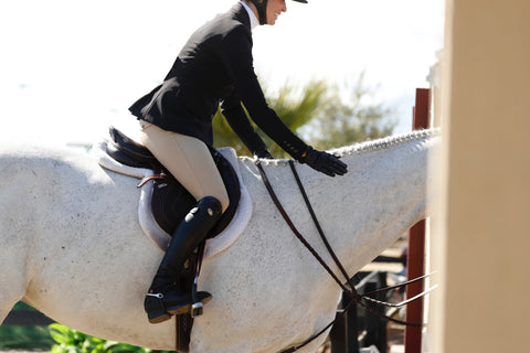 Helen Pollock of Life Equestrian wearing Parlanti Boots, riding with black tall boots.