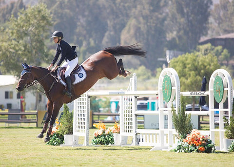 Natasha Traurig showjumping wearing white Mastermind Breeches