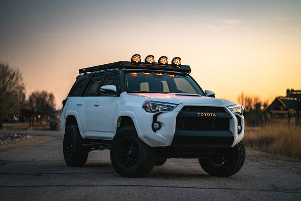 Alpha 5th GEN 4Runner roof rack with four baja designs LP6 in the integrated front fairing cutout.