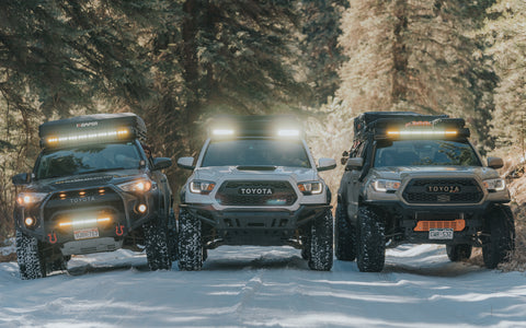 Line up of upTOP vehicles with roof racks on a 4Runner and Tacoma