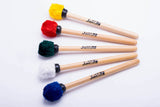 Surdo mallets with wooden handles made by IVSOM. Multi colored heads laying together.