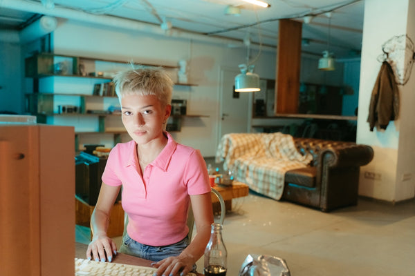 A young woman typing on a computer