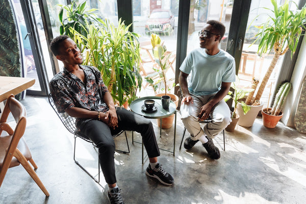 Two men talking at a coffee shop
