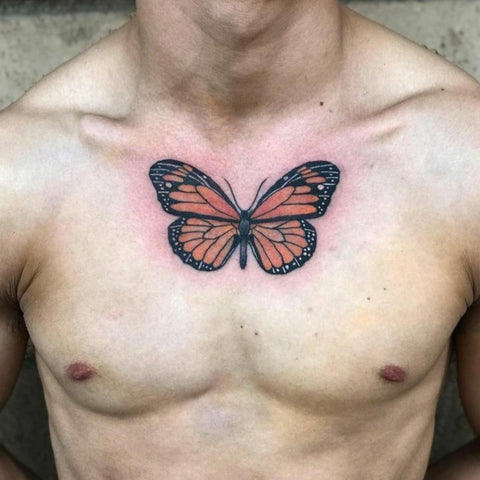 Fine line butterfly tattoo on the chest