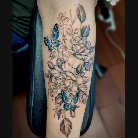 Fine line flower tattoo on the left inner forearm