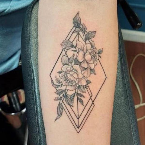 Fine line rose tattoo on the inner forearm