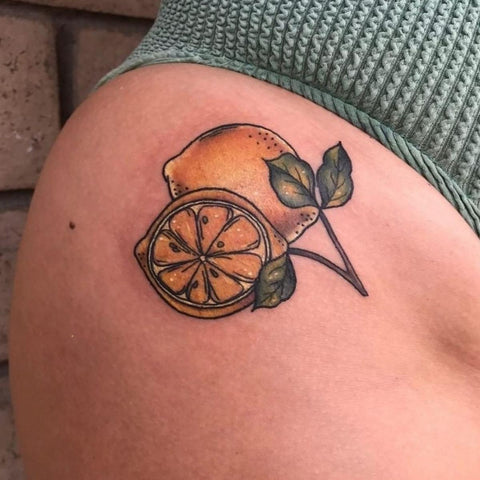 Watercolor orange tattoo on the inner arm