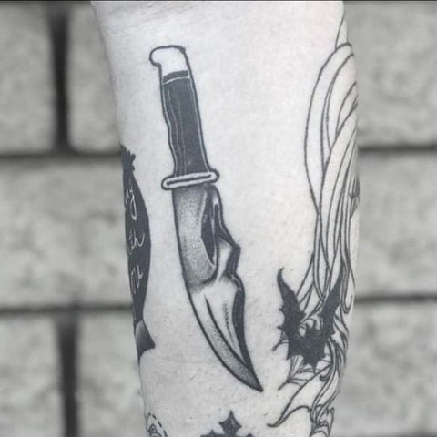 Premium Vector | Tattoo design knife and skull head line art black and white