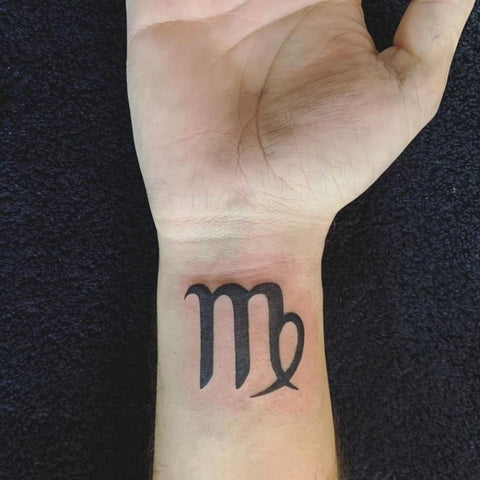 Minimalist Virgo zodiac symbol tattoo on the wrist