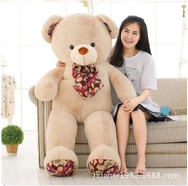 girl hugging giant teddy bear