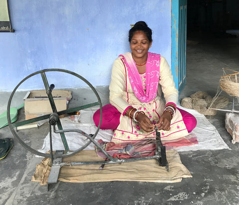 Woman spinning peace silk yarn in India