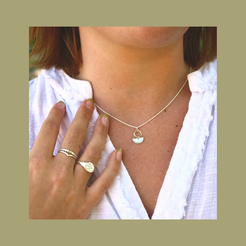 necklaces and rings on girl in white dress