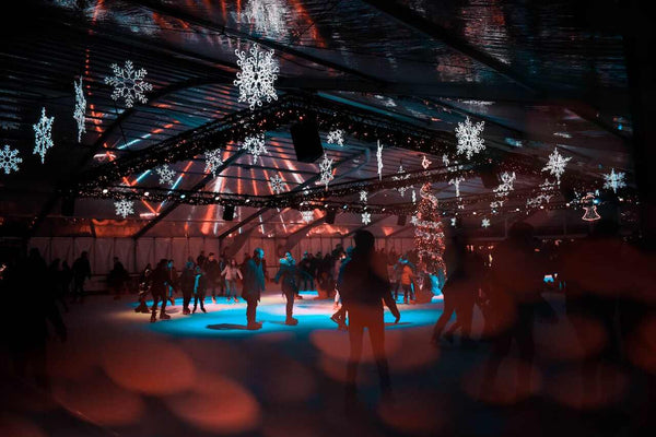 An ice skating rink filled with people and winter decorations