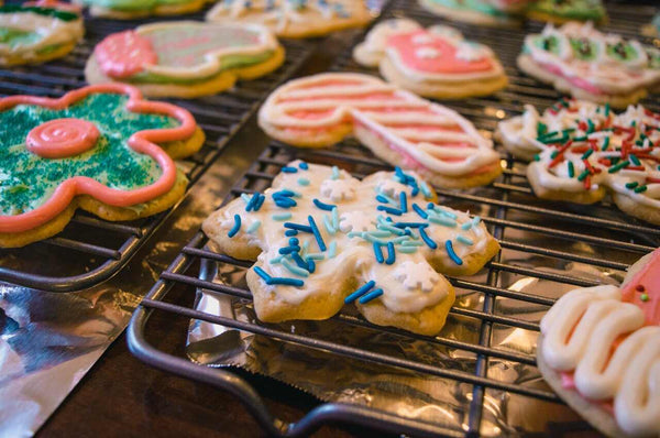 Sugar cookies on rack decorated with icing and sprinkles