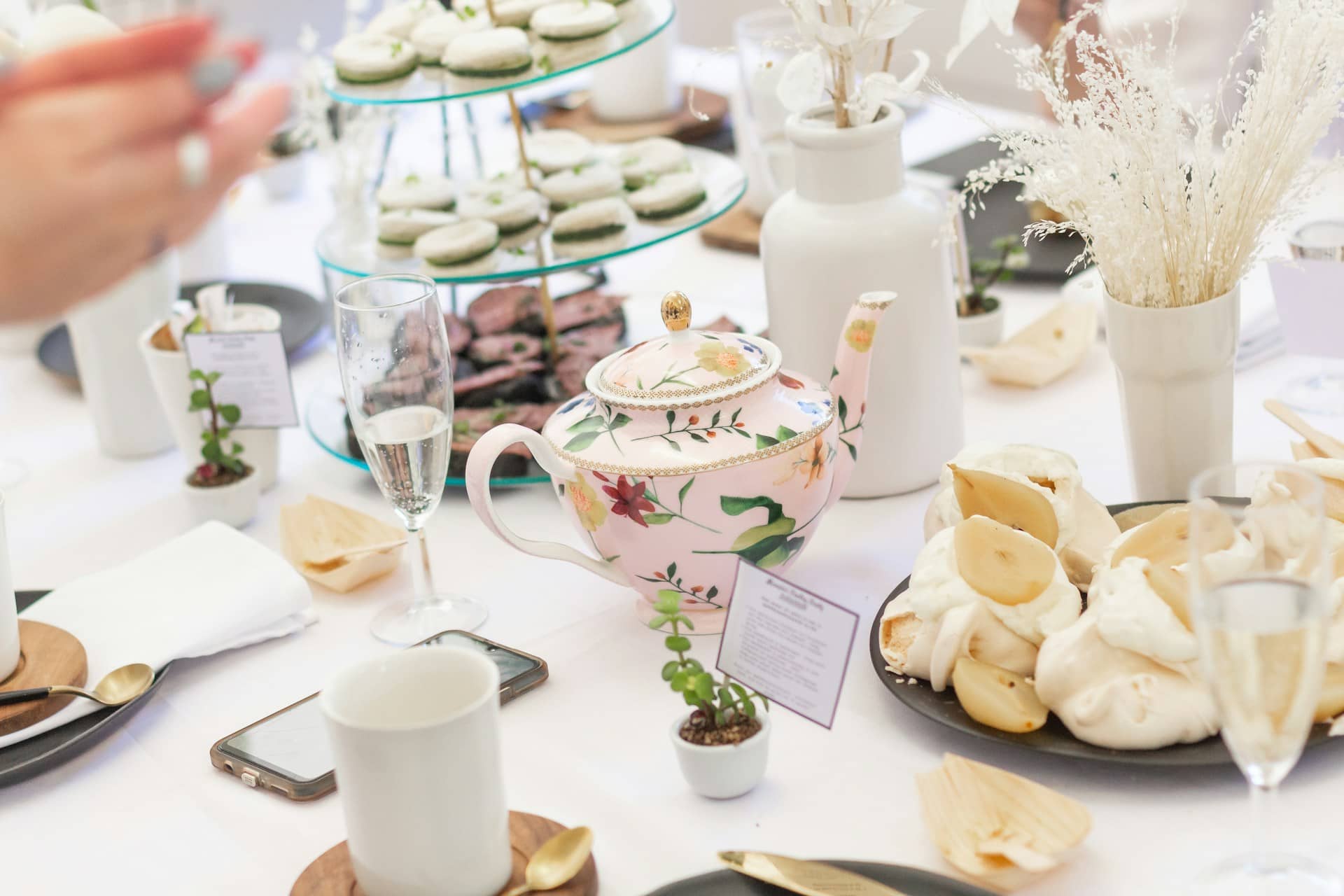 A table is set with tea party food and drinks