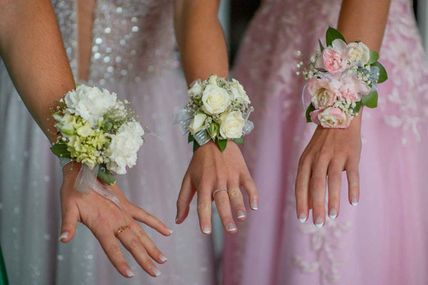 Three women in dresses with corsages