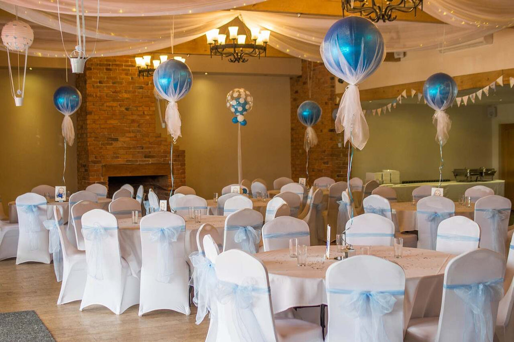 Wedding balloon decor used to accent tables inside a wedding venue