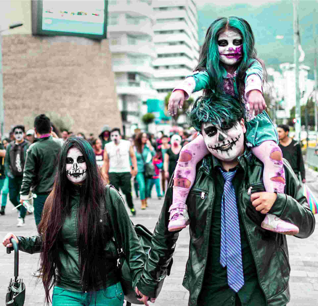 A man, woman, and child dressed as zombies