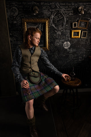 Relaxing with a dram, wearing Isle of Skye Kilt with Nicolson Tweed waistcoat