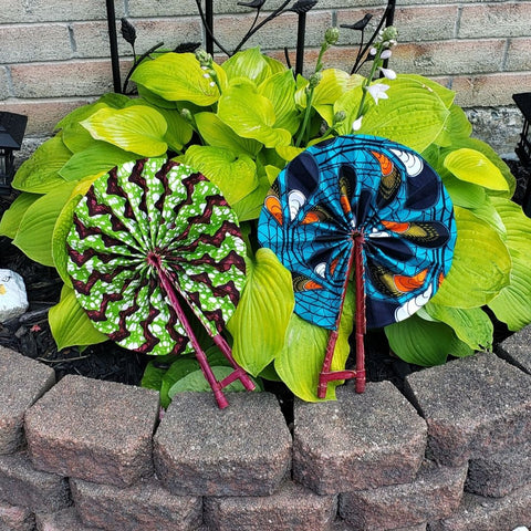 Green and pink African Print hand fan and a Blue and orange African print folding hand fan for summer. Kejeo Designs