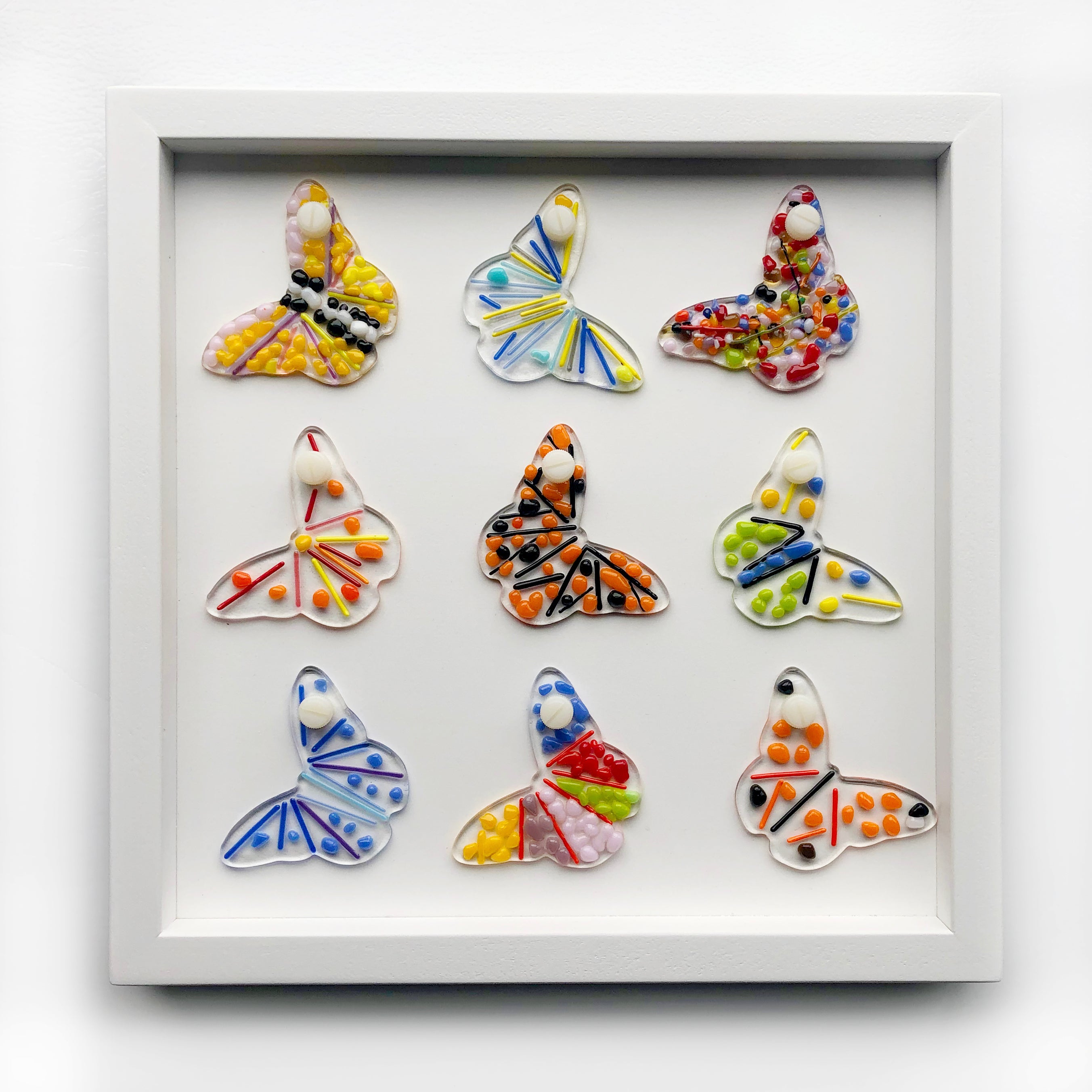 Make a collaborative piece of glass art to hang in your home! Our Home Community frame is a sleek, interchangeable frame that displays 9 colorful glass suncatchers designed by YOU! You have a choice of 3" suncatcher shapes: circle, square, butterfly, flower, bird, bee, and heart. Orders take approximately one week to put together, we will be in touch with your order status. Materials will come in bulk/classroom style, easiest for creating together! Kits come with mixed frit and stringer in the rainbow spectrum and neutrals. For an additional fee, we can add small pieces of sheet glass from our "Raw Bar" for $1/oz or $16/lb. *Due to size and weight constraints, this kit is available only for Local Pick Up. Please call with any order questions or to arrange shipping.