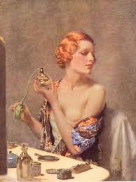 A elegantly coiffed red haired, pale skinned 1920s woman loosely wrapped in a colorful dressing gown sits in front at a vanity table and sprays perfume on her arched neck from an old fashioned bulb pump perfume atomizer