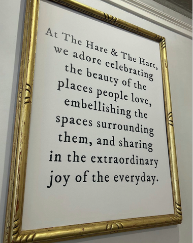 A photo of the mission statement of The Hare & The Hart, framed and hung above the fireplace