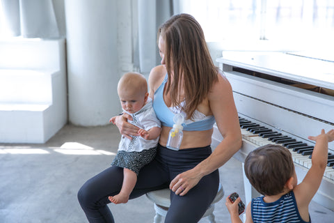 A new mom is pumping in Sweat and Milk's Oceane Nursing and hands free pumping bra