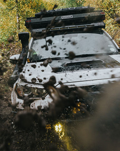 Alan and Glen mudding in offroad vehicle