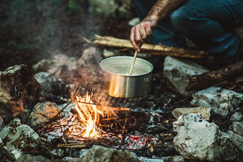 Camper cooking a one-pot meal.