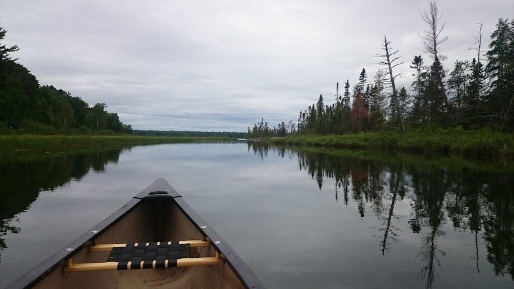 front of canoe on water at big bay town park