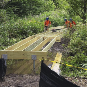 group of people building hiking trail frame