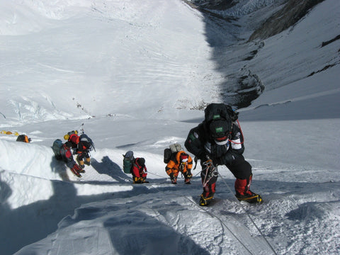 Group of ice climbers mountaineering together safely.