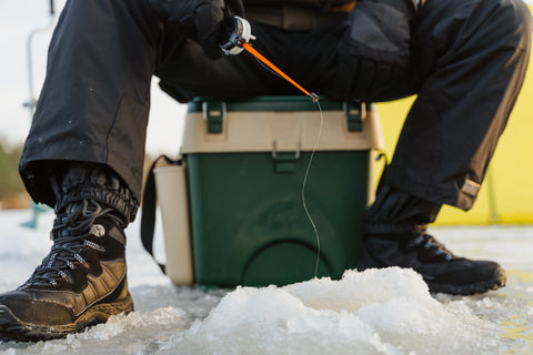 Lower body shot of man ice fishing at Lake Gogebic.