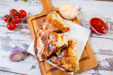 Pizza quesadilla on a wooden cutting board