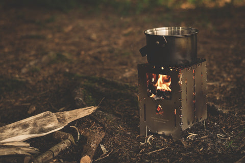 soup in a pot on a campfire