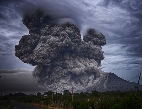 Powerful volcanic eruption in the distance.