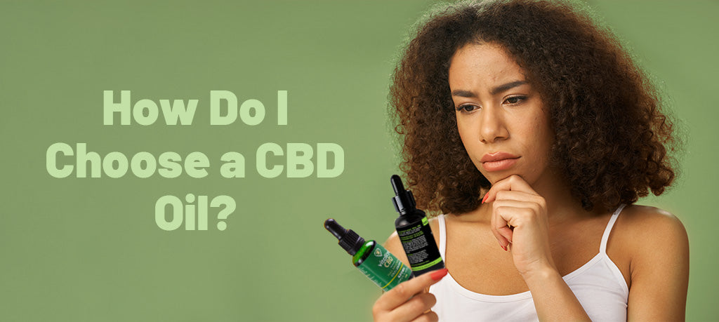 Woman pondering over two different oil bottles, how do I choose a CBD oil?